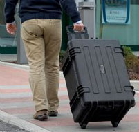 A man pulling an explorer 5833 cases using its Wheels and Telescopic Handle