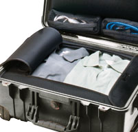 a close up of a Peli 1560LOC Laptop Overnight Case storage compartment with a blue shirts inside