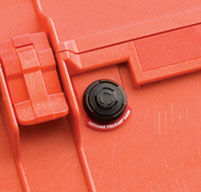 Close up of an orange peli 1460ems cases automatic pressure equalization valve which balances pressure and keeps water out.