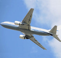 an image of an airplane flying through a blue sky