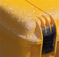 a close up of a black peli Storm case with dust on the lid