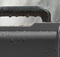 a close up of a black peli Storm case near a waterfall to show the case is watertight